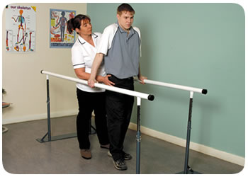 Patient and physio session using paralell bars