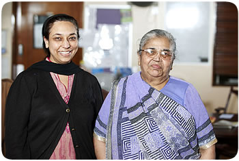 An elderly asian lady with a younger member of her family