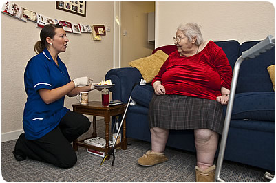 Intermediate care being provided to an eldery lady in her own home