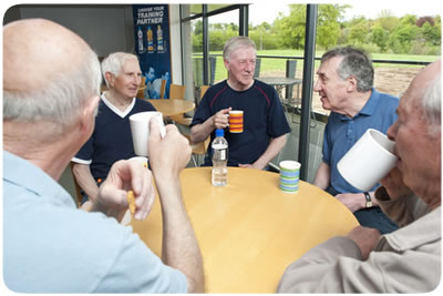 Group of male carers enjoying a coffee break at a day care centre