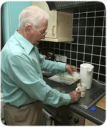 man in the kitchen making a cup of tea 