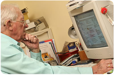 Elderly man on a computer